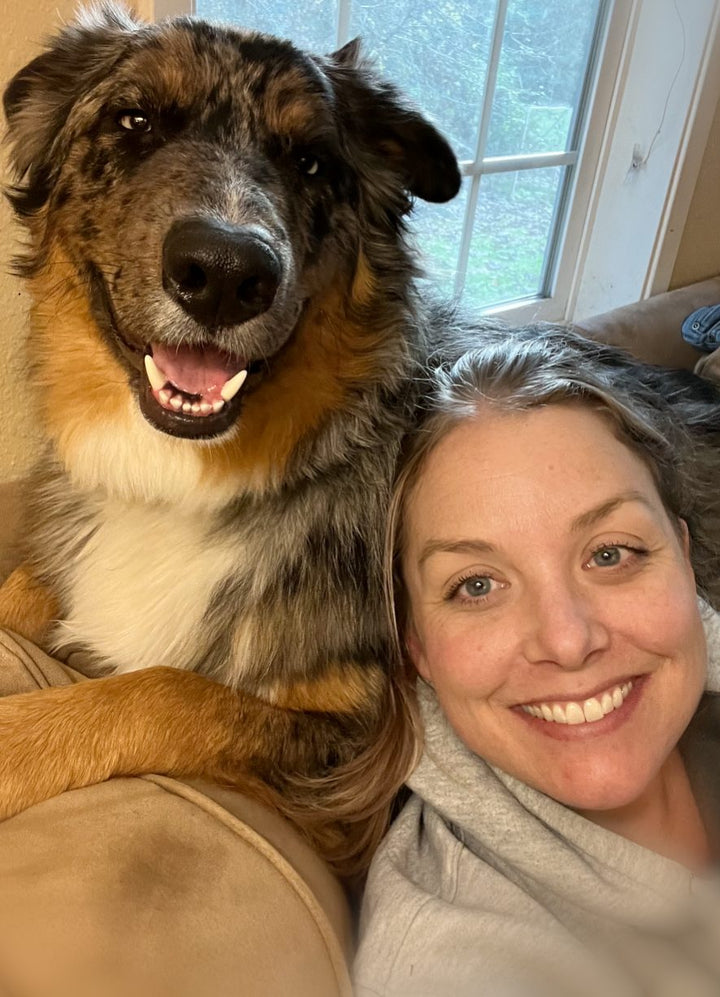 Gus the dog with owner, both calm and relaxed thanks to Auralief Chews
